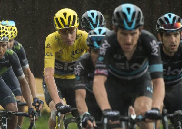 Job nearly done for Chris Froome as his trusted team-mates, led by Geraint Thomas, surround him during the penultimate stage. Picture: Peter Dejong/AP