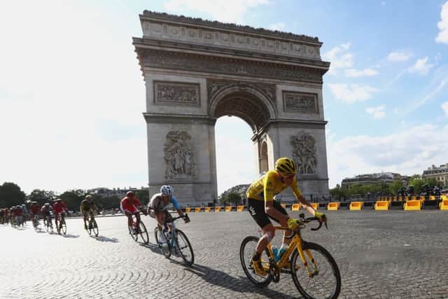 Chris Froome cycles past the Arc de Triomphe, left, and raises the trophy following his victory. Picture: Getty Images