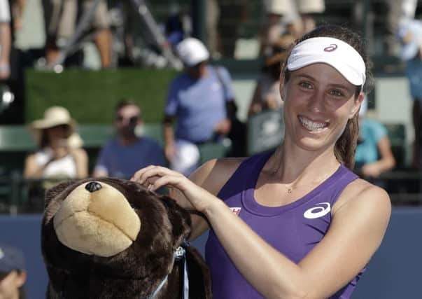 Johanna Konta holds a stuffed bear, the symbol of California, after her victory at Stanford. Picture: AP
