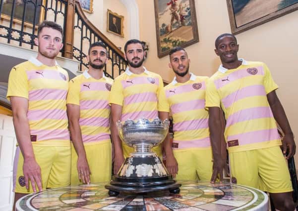 Wearing the clubs new  change strip, Alim Ozturk,  centre, with the Rosebury Cup, is flanked by  team-mates, from left,  John Souttar, Igor Rossi, Faycal Rherras, and Arnauld Djoum at Dalmeny House, South Queensferry. Picture: Ian Georgeson