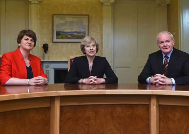 Theresa May with Northern Ireland's First Minister Arlene Foster and Deputy First Minister Martin McGuinness. Picture: AFP/Getty Images