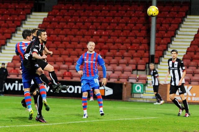 Iain Vigurs (left) heads in to complete his hat-trick. Picture: SNS.