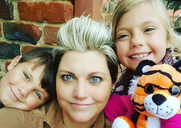 Riekie - who desperately needs a bone marrow transplant - with her two young children. Picture: Contributed
