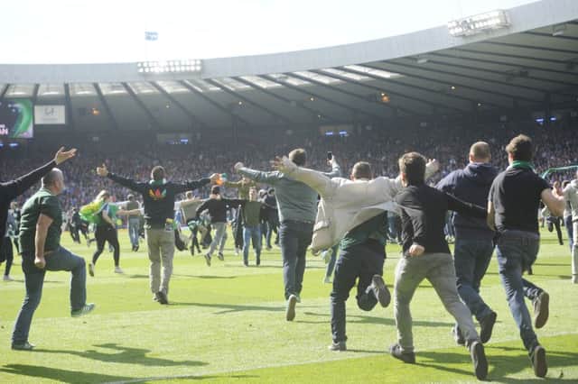 Hundreds of Hibs fans evaded the pitch after full-time. Picture: Greg Macvean