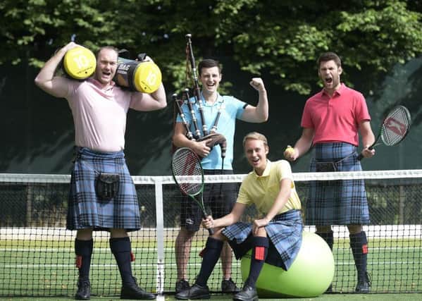 Craig McInnes, Richard Gill and Keith Bowes from Johnstone Pipe Band work with personal trainer Lloyd Stevenson (centre). Picture: Sandy Young/PA Wire
