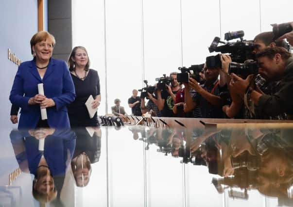 German chancellor Angela Merkel is the centre of attention at the news conference on Thursday. Picture: AP