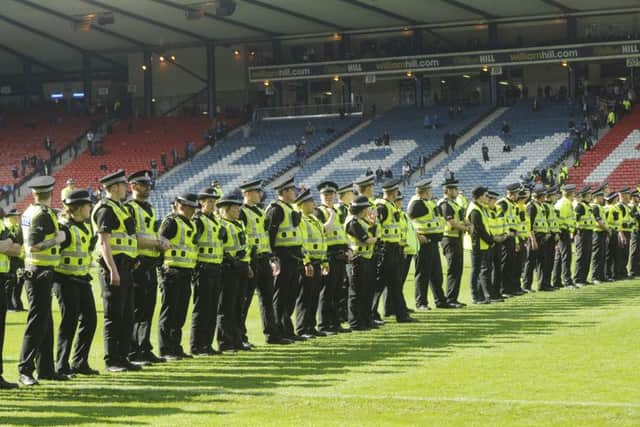 Police on the pitch after the game. Greg Macvean