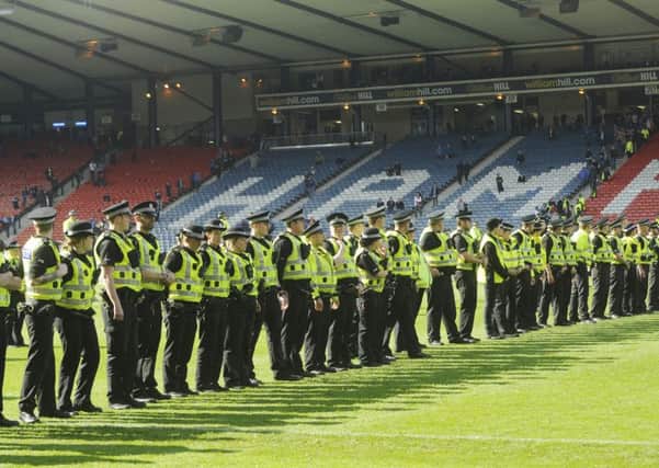 Police on the pitch after the game. Greg Macvean