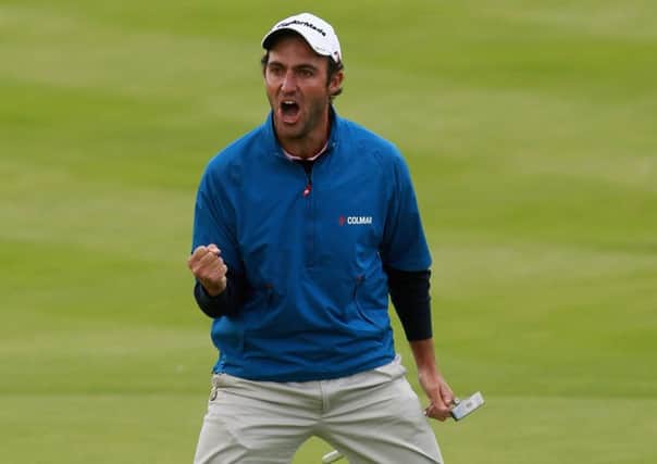 Edoardo Molinari celebrates after sinking a putt for a birdie. Picture: Andrew Redington/Getty Images
