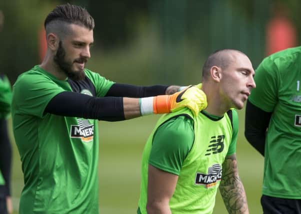 Celtic's Leonardo Fasan (left) gives skipper Scott Brown a neck rub during training ahead of the game against Barcelona. Picture: Craig Williamson/SNS
