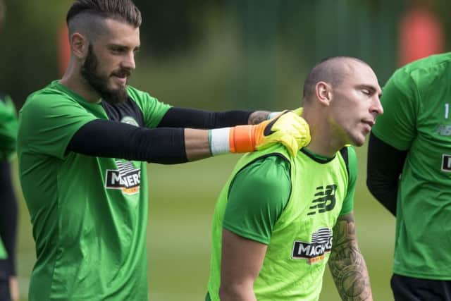Celtic's Leonardo Fasan (left) gives skipper Scott Brown a neck rub during training ahead of the game against Barcelona. Picture: Craig Williamson/SNS