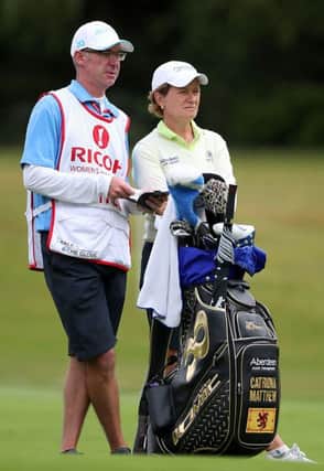 Catriona Matthew and her caddie, husband Graeme, ponder a shot during the second round at Woburn. Picture: PA