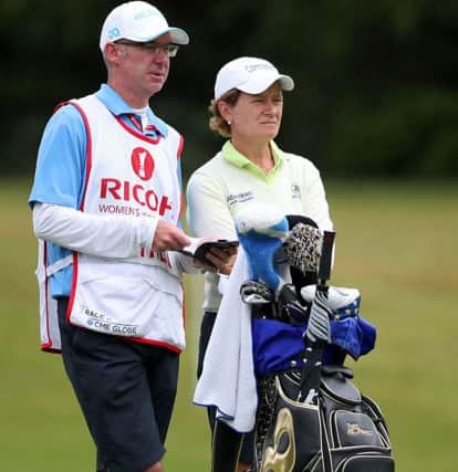 Catriona Matthew and her caddie, husband Graeme, ponder a shot during the second round at Woburn. Picture: PA