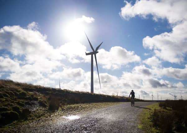 Wind farms such as this one at Eaglesham have helped Scotland cut greenhouse gas emissions to nearly half what they were in 1990. Photograph: John Devlin