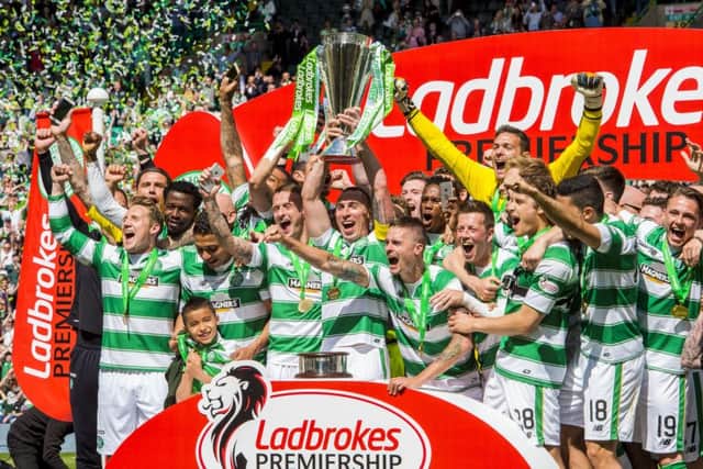 Celtic players celebrate their Premiership title in May. Photograph: SNS