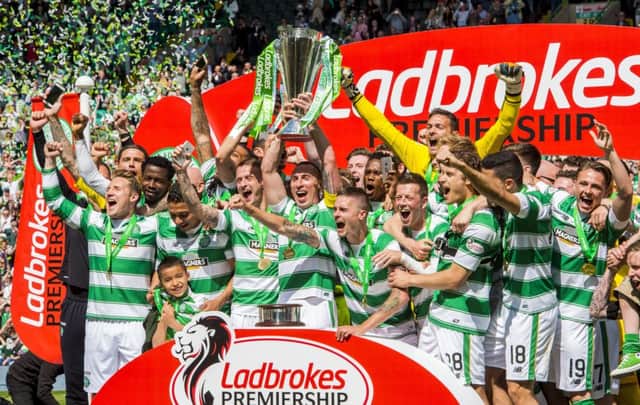 Celtic players celebrate their Premiership title in May. Photograph: SNS