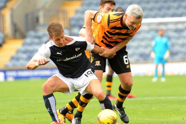 Rudi Skacel, left, gets involved in some arm wrestling with Jim Goodwin as Alloa topped the group. Photograph: Walter Neilson
