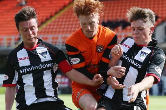 Dundee Uniteds Simon Murray gets caught between Pars pair Joe Cardle and Lewis Spence. Picture: Getty Images