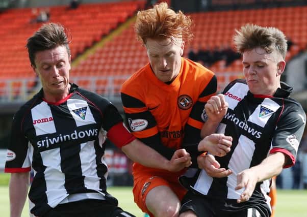 Dundee Uniteds Simon Murray gets caught between Pars pair Joe Cardle and Lewis Spence. Picture: Getty Images