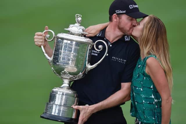 Jimmy Walker kisses his wife Erin while holding the Wanamaker Trophy. Picture: Getty Images