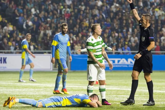 Leigh Griffiths is booked after clashing with Igor Shitov. Picture: SNS