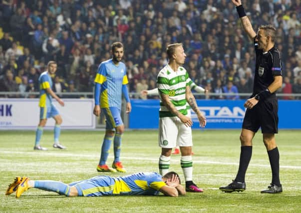 Leigh Griffiths is booked after clashing with Igor Shitov. Picture: SNS
