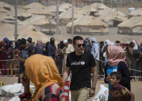 Ewan McGregor walks through a section of the Debaga IDP camp in northern Iraq. Picture: PA