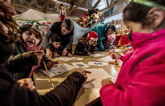 Migrant children attend a lesson in a makeshift school in the so-called Jungle migrant camp in Calais. Picture: AFP/Getty Images