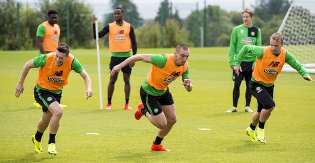 Celtic captain Scott Brown, centre, sprints with Callum McGregor, left, and Leigh Griffiths in training. Picture: SNS