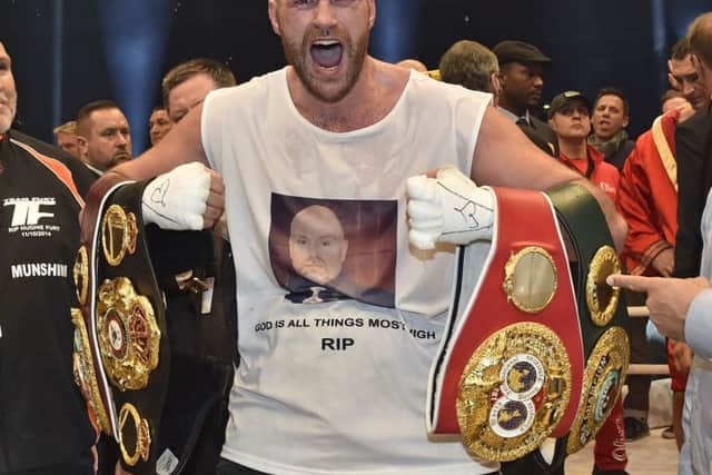 Tyson Fury celebrates his world heavyweight title victory against Ukraine's Wladimir Klitschko last year. Picture: Martin Meissner/AP