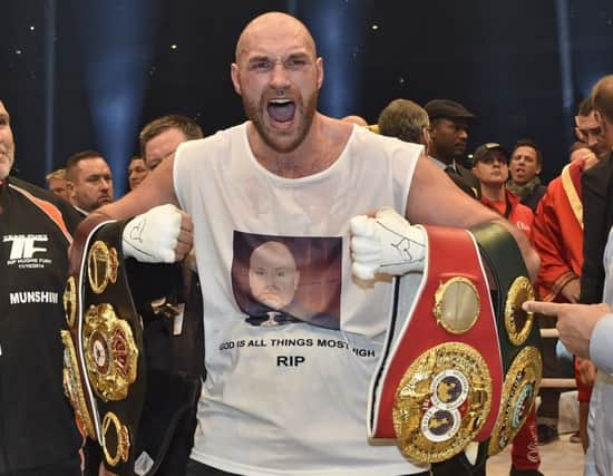 Tyson Fury celebrates his world heavyweight title victory against Ukraine's Wladimir Klitschko last year. Picture: Martin Meissner/AP
