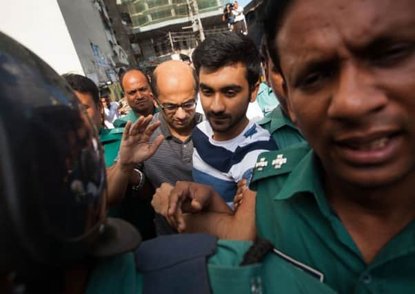 Hasnat Karim and Tahmid Hasib Khan are taken into custody. Picture: AFP/Getty Images