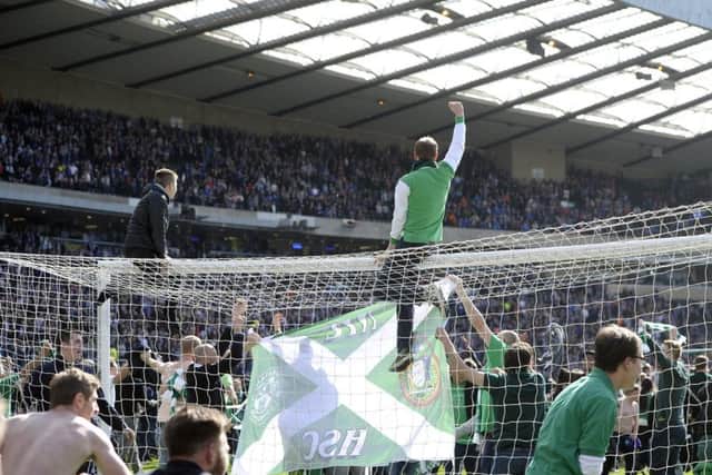 Hibs fans celebrate on the pitch after winning the Scottish Cup. Picture: Neil Hanna