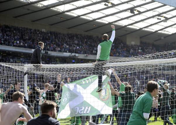 Hibs fans celebrate on the pitch after winning the Scottish Cup. Picture: Neil Hanna