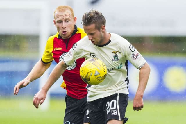Inverness winger Billy King shields the ball from Partick defender Ziggy Gordon. Pic: SNS