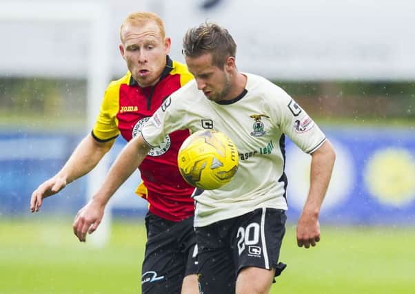Inverness winger Billy King shields the ball from Partick defender Ziggy Gordon. Pic: SNS