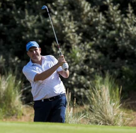 Anthony Wall bear fellow Englishman Oliver Fisher at the 22nd in their semi-final at Archerfield Links. Picture: PA