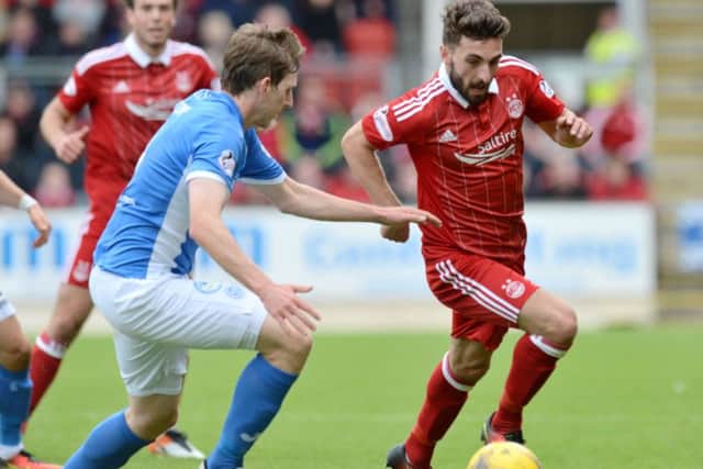Graeme Shinnie tries to go round St Johnstone's Blair Alston. Picture: SNS