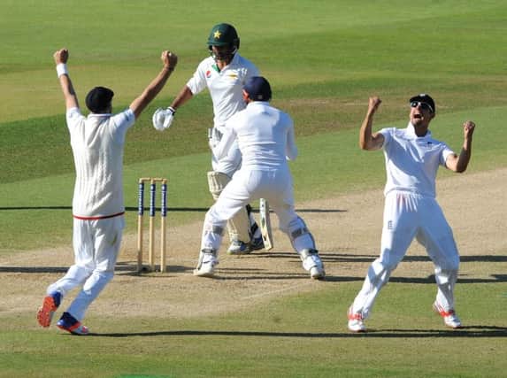 England captain Alastair Cook (right) celebrates after England beat Pakistan by 141 runs.