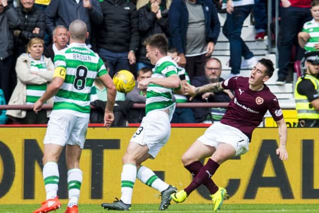 Scott Brown watches on as Jamie Walker goes to ground inside the Celtic penalty area. Picture: SNS