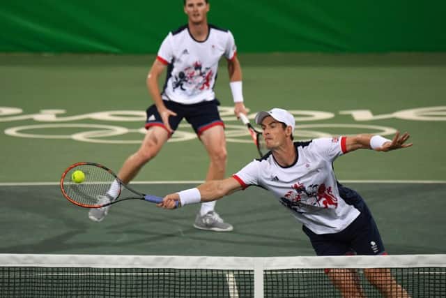 Andy Murray (right) and Jamie Murray in action against Andre Sa and Thomaz Bellucci of Brazil. Picture: AFP/Getty