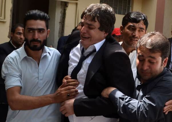 Pakistani men comfort a lawyer after the killing of his colleagues in a bomb explosion at a government hospital premises in Quetta
Picture: AFP/Getty Images
