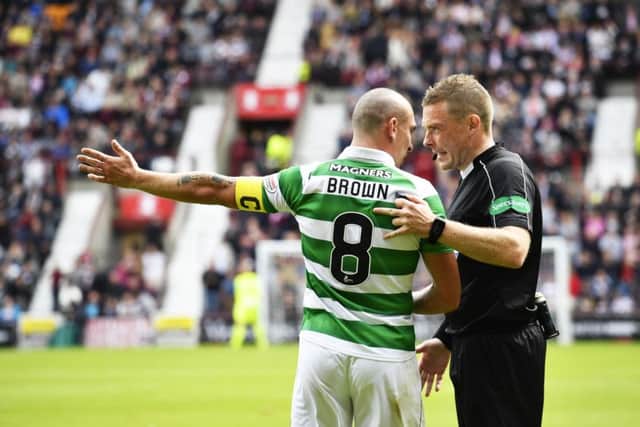 Referee John Beaton talks to Scott Brown during the match. Picture: SNS