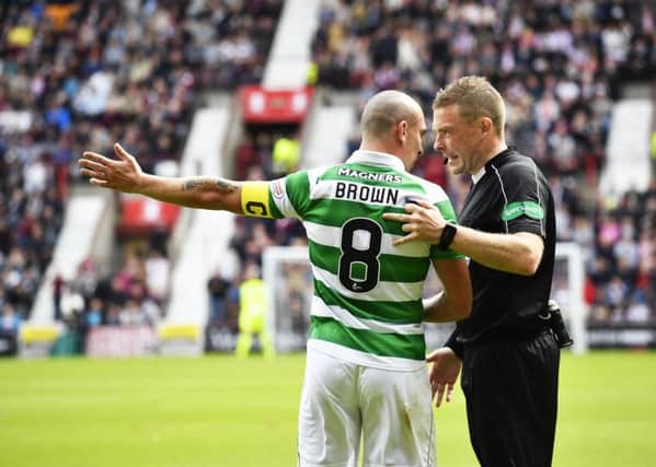 Referee John Beaton talks to Scott Brown during the match. Picture: SNS