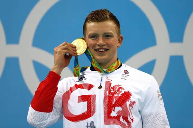 Gold medalist Adam Peaty of Great Britain poses on the podium during the medal ceremony for the Men's 100m Breaststroke Final. Picture: Getty
