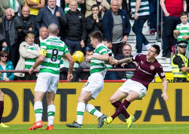Hearts' Jamie Walker, right, goes down in the box and a penalty is awarded against Celtic. Teh winger has been charged with diving. Picture: SNS
