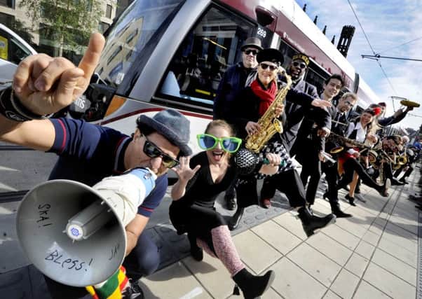 Musicians from the Melbourne Ska Orchestra joined up with Fringe visitors to form a ska conga on Edinburgh trams.
 Picture: Colin Hattersley