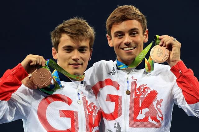 Daniel Goodfellow, left, and Tom Daley and celebrate with their bronze medals after their win in the 10m synchronised diving. Picture: PA