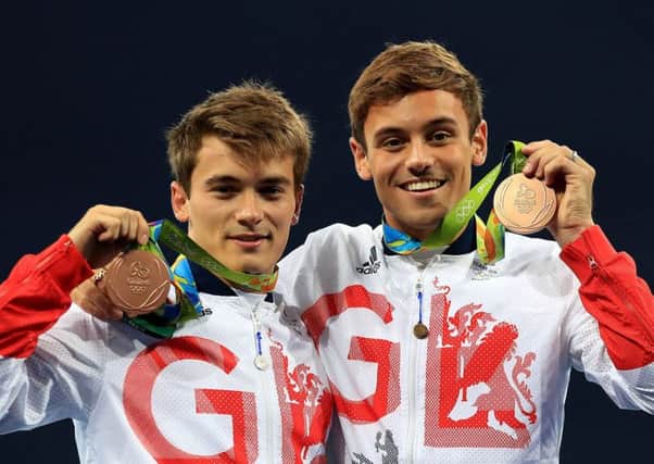 Daniel Goodfellow, left, and Tom Daley and celebrate with their bronze medals after their win in the 10m synchronised diving. Picture: PA