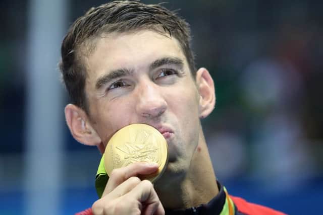 Michael Phelps with his 21st Olympic gold medal after the Men's 4 x 200m Freestyle Relay Final win for the USA